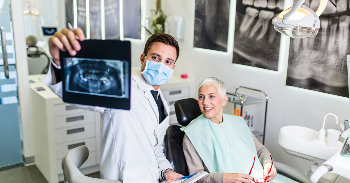 a woman counsels with her dentist about dental crowns