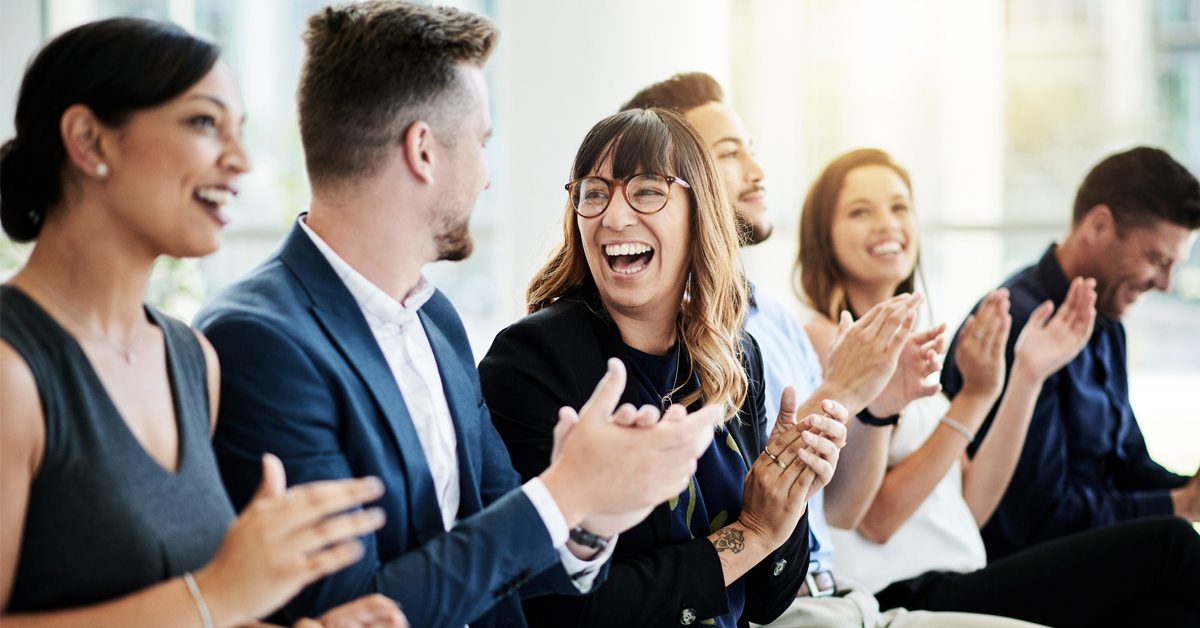 dental professionals applaud after an industry presentation