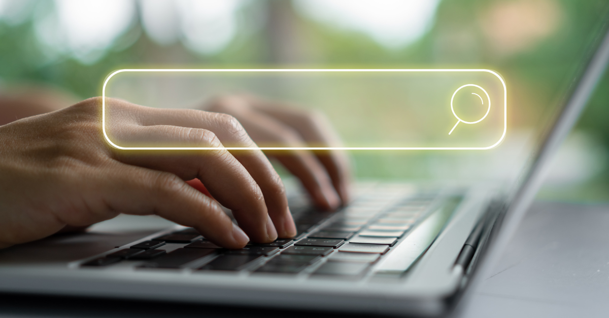 Hands typing on laptop keyboard with transparent search bar overlay