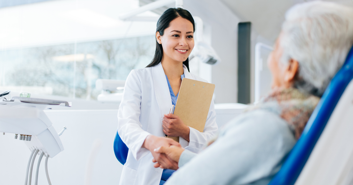 a dentist meets with a patient and understands how positive language will improve their relationship