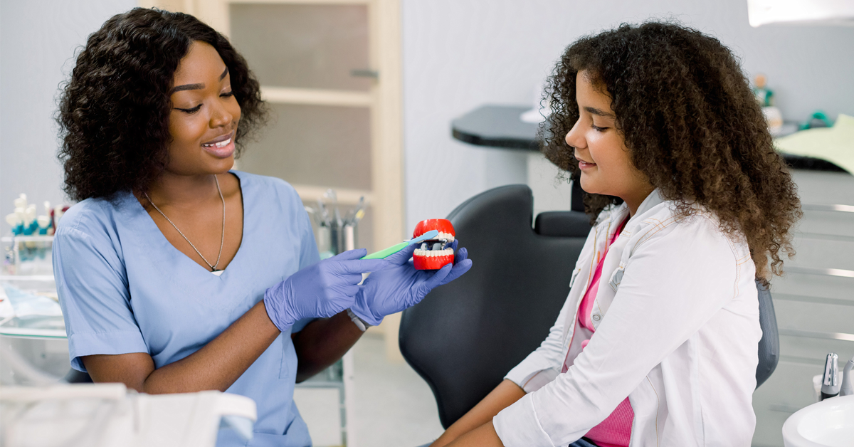 a young girl is having a positive visit to the dentist