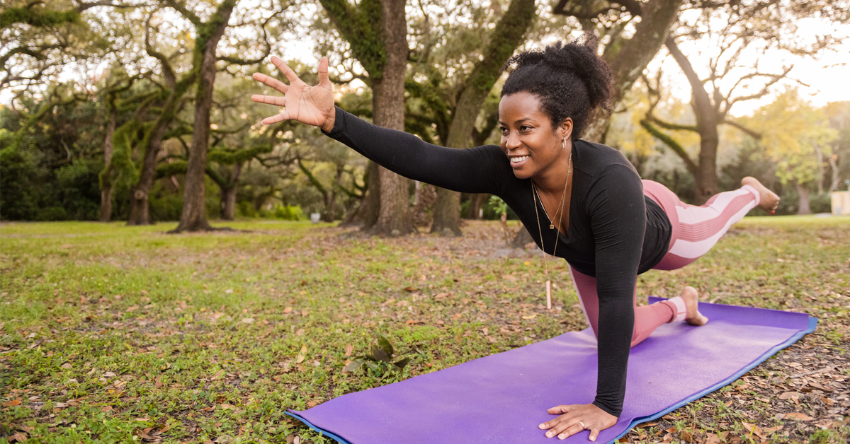 a woman practices yoga on her day off. yoga is one of three workouts ideal for office workers to improve posture and reduce stress