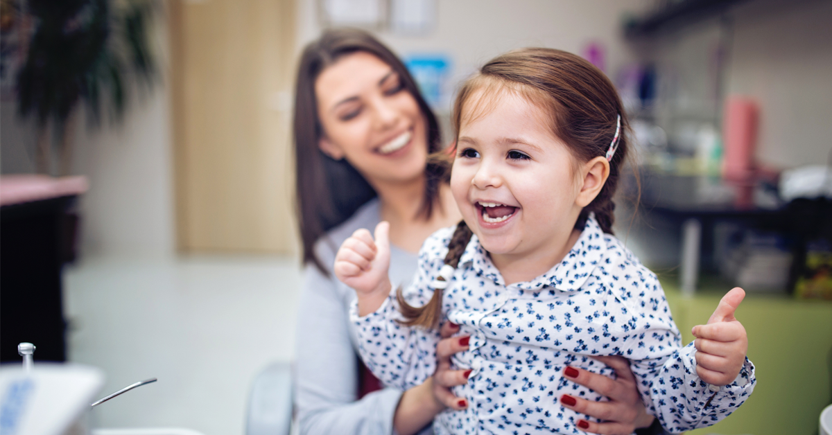 a child is happy to be at the dentist 