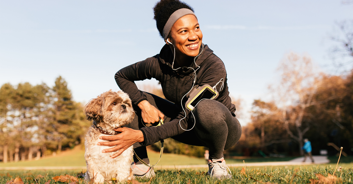 a Black woman walks her dog