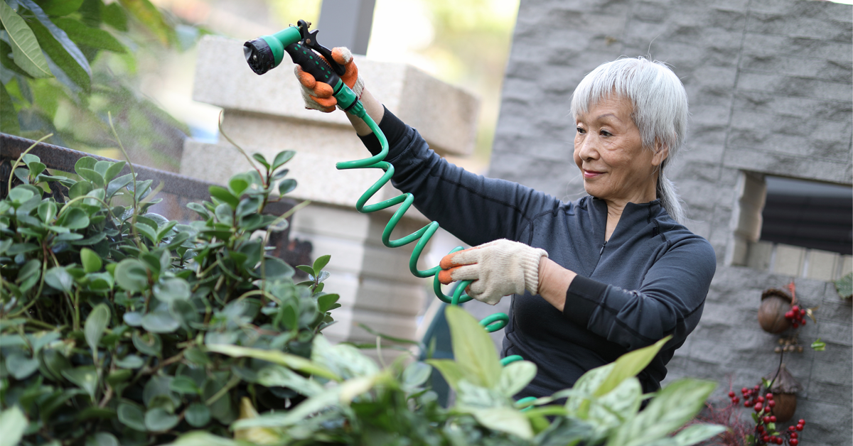 a woman uses outo of office time to water her plants, a great way to get out in nature