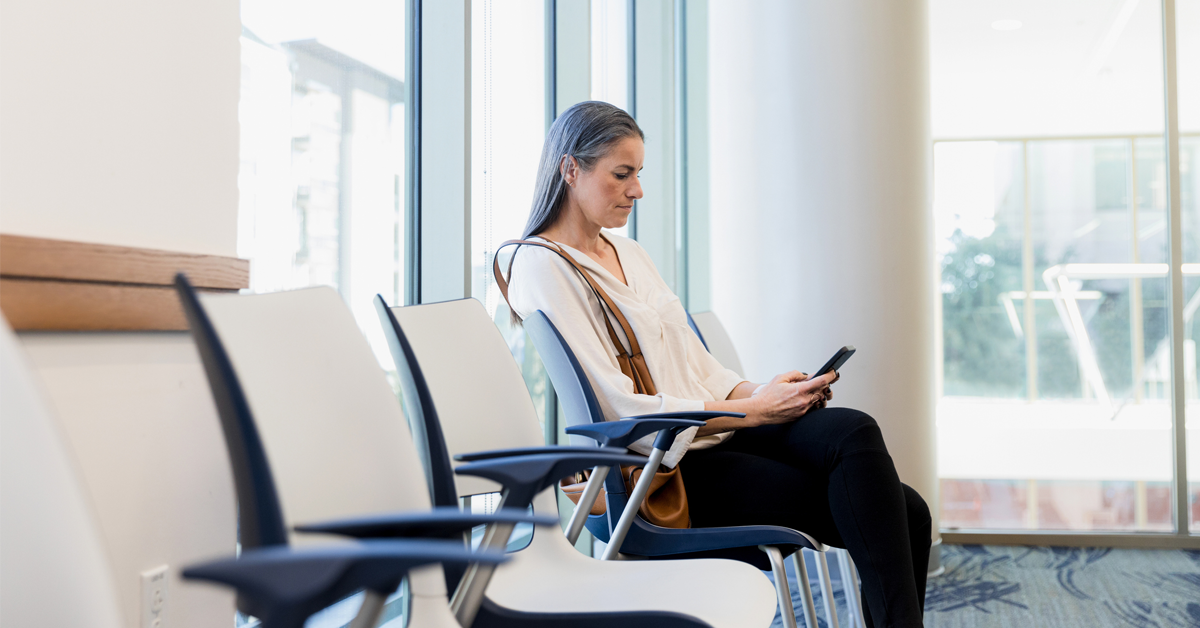 a woman waits in an uncomfortable waiting room