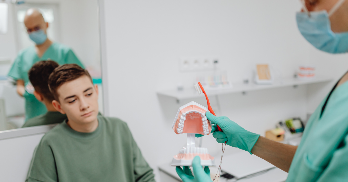 Dentist using a visual aid demonstration for a patient