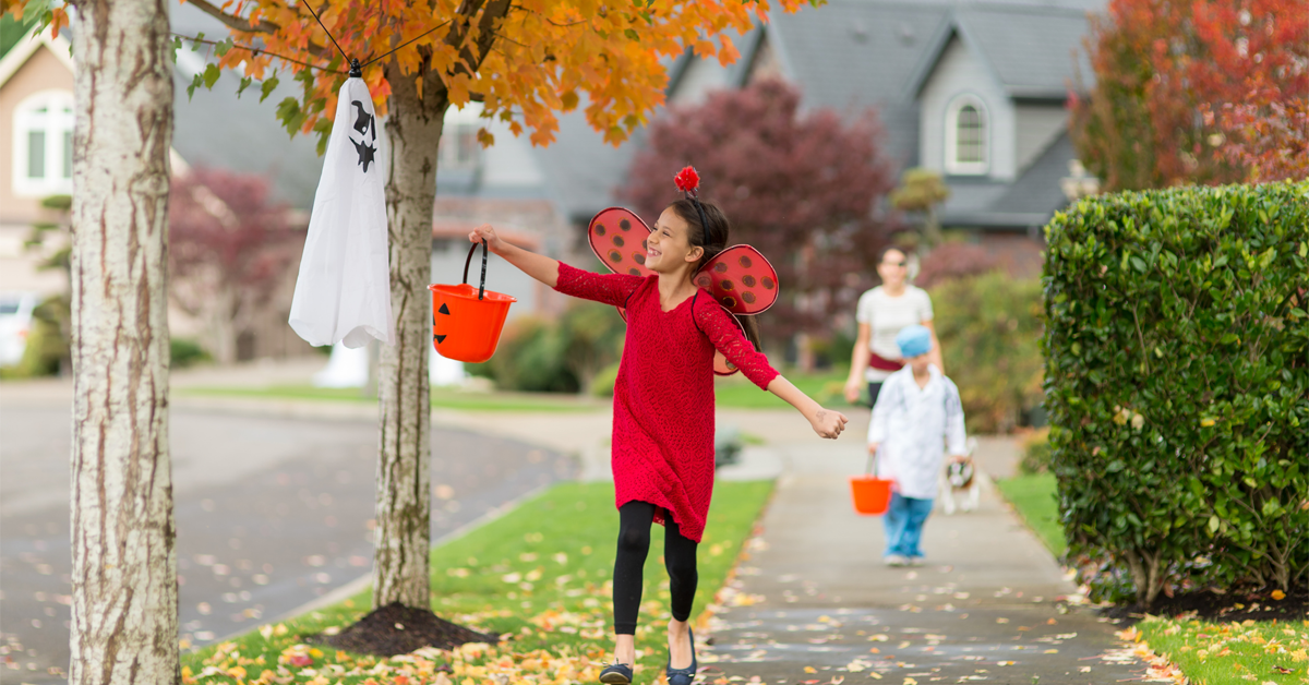 a young girl dressed as a ladybug goes trick-or-treating